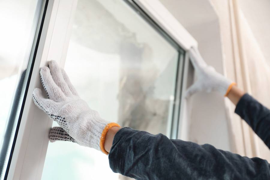 Installing a white window while wearing gloves