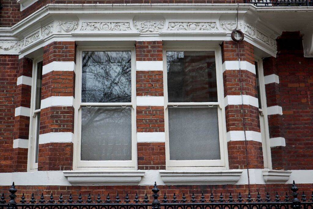 A pair of sash windows in red brick house