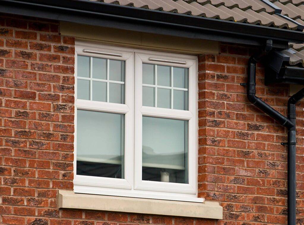 A casement window in a red brick house.